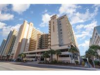 Oceanfront building with parking and palm trees at 501 S Ocean Blvd. # 806, North Myrtle Beach, SC 29582