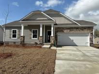 Charming single-story home with stone accents, attached two-car garage, and manicured lawn at 541 Honeyhill Loop, Conway, SC 29526