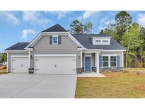 Charming single-Gathering home features gray siding, stone accents, and a two-car garage at 556 Honeyhill Loop, Conway, SC 29526