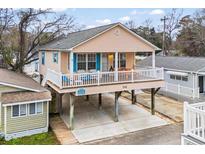 Elevated view of beach house with two stories, deck, and parking underneath at 6001 - 1563 S Kings Hwy., Myrtle Beach, SC 29575