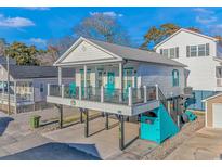 Elevated beach house with a porch and a turquoise storage area at 6001-1340 S Kings Hwy., Myrtle Beach, SC 29575