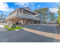 Elevated beach house with large deck, carport, and fenced yard at 6001-1909 S Kings Hwy., Myrtle Beach, SC 29575