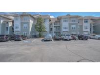 Exterior view of a condo building with parking lot and landscaping at 70 Addison Cottage Way # 319, Murrells Inlet, SC 29576