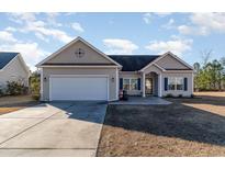 Charming one-story house with a two-car garage and landscaped lawn at 817 Payne Ct., Conway, SC 29526