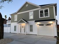 Charming two-story home features a well-manicured lawn, a driveway, and an attached garage at 931 Edge Dr., North Myrtle Beach, SC 29582