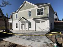 Charming two-story home with a white garage door, fresh concrete driveway, and inviting front entrance at 931 Edge Dr., North Myrtle Beach, SC 29582