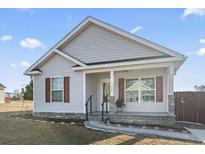 Charming single-story home featuring a covered entryway, well-manicured lawn, and stone accents at 112 Cappin Ln., Aynor, SC 29511
