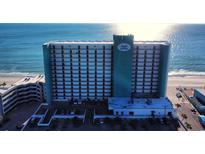 Aerial view of beachfront high rise building with ocean and city views at 1210 N Waccamaw Dr. # 702, Murrells Inlet, SC 29576