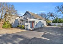 Gray cottage with balcony, parking, and landscaping at 1701-F Edge Dr., North Myrtle Beach, SC 29582