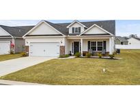 Craftsman style home with brick accents, two-car garage, and landscaped lawn at 178 Lakota Loop, Longs, SC 29568