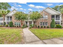 Brick building with walkway, landscaping, and balconies at 19 Pistachio Loop # 19-F, Murrells Inlet, SC 29576