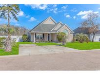 Brick and shingle front elevation of charming house with manicured lawn and driveway at 204 Atoll Dr., Myrtle Beach, SC 29588