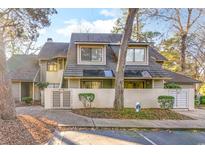 Exterior view of charming townhome with gray siding and a gray roof at 211 Baslow Ct. # 2-C, Myrtle Beach, SC 29572