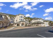 Exterior of a charming three-story building with palm trees and a parking lot at 2180 Waterview Dr. # 637, North Myrtle Beach, SC 29582