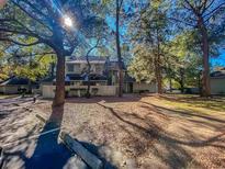 Inviting townhome with manicured lawn and mature trees providing shade and curb appeal at 222 Westleton Dr. # 18-C, Myrtle Beach, SC 29572