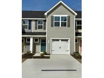 New construction townhome features a white garage door, complementary shutters, and a concrete driveway at 288 Myrtle Meadows Dr # 505E, Conway, SC 29526