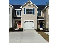 New townhome featuring a garage and colorfully painted front doors at 302 Myrtle Meadows Dr # 511B, Conway, SC 29526