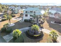 Luxury waterfront home with circular driveway and lush landscaping at 47 Isle Of Palms Dr., Murrells Inlet, SC 29576