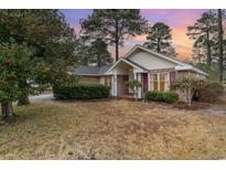 Brick ranch home with a landscaped yard and attached garage at 4712 Southern Trail, Myrtle Beach, SC 29579
