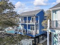 Two-story blue house with large decks, offering ocean views and ample outdoor space at 6001 South Kings Hwy., Myrtle Beach, SC 29575