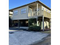 Two-story home with a covered porch, attached garage, and landscaping at 9502 Knights Ct., Myrtle Beach, SC 29572