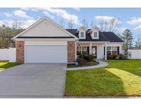 Charming one-story home with brick accents and a well-manicured lawn at 1000 Marley St., Conway, SC 29526