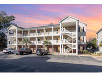 Two-story building exterior with parking and surrounding landscape at 1058 Sea Mountain Hwy. # 1-303, North Myrtle Beach, SC 29582