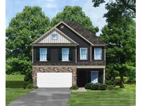 Two-story house with gray siding, stone accents, and a two-car garage at 1220 Mill Banks Dr., Longs, SC 29568