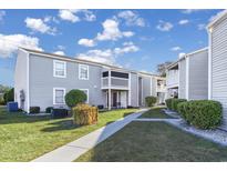 Gray building exterior with walkway, landscaping, and screened porch at 1356 Glenns Bay Rd. # 208M, Surfside Beach, SC 29575