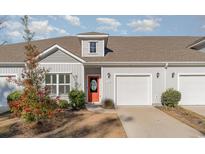 House exterior with gray siding, orange door, and two-car garage at 192 Sea Shell Dr. # 22, Murrells Inlet, SC 29576