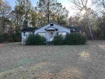 Ranch style home with mature landscaping and a large yard at 21851 Choppee Rd., Hemingway, SC 29554