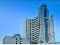 Stunning exterior view of the Carolinian Beach Resort with a clear blue sky backdrop at 2504 Ocean Blvd. N # 232, Myrtle Beach, SC 29577