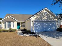 House exterior featuring a two-car garage and well-manicured lawn at 2543 Whetstone Ln., Myrtle Beach, SC 29579