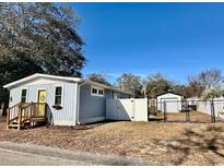 Quaint light blue home with fenced yard and detached shed at 2601 Ye Olde Kings Hwy., North Myrtle Beach, SC 29582