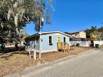 Cute blue house with yellow door, and small front yard at 2601 Ye Olde Kings Hwy., North Myrtle Beach, SC 29582