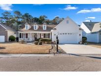 Beautiful exterior of a charming house with a well-manicured lawn and a two-car garage at 29 Saltwind Loop, Murrells Inlet, SC 29576