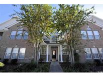 Brick front exterior of charming 2-story townhome with landscaping at 4657 Fringetree Dr. # C, Murrells Inlet, SC 29576