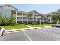 Attractive three-story building with ample parking and lush landscaping at 5801 Oyster Catcher Dr. # 1624, North Myrtle Beach, SC 29582