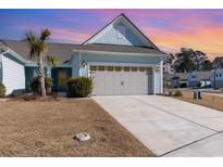 Light blue exterior house with gray garage door and landscaping at 5876 Cremona Dr., Myrtle Beach, SC 29577
