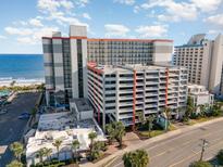 An aerial view of a beachfront hotel featuring multiple stories, balconies, and convenient on-site parking at 7200 N Ocean Blvd. # 765, Myrtle Beach, SC 29572