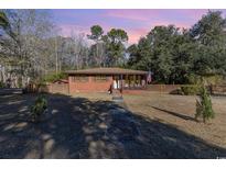 Brick ranch house with a spacious yard and wooden fence at 1043 Holt Rd., Conway, SC 29526