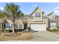 Attractive brick front elevation with two-car garage and landscaping at 3210 Volterra Way, Myrtle Beach, SC 29579