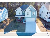 Two-story house with light blue siding, stone accents, and a two-car garage at 3339 Moss Bridge Ln., Myrtle Beach, SC 29579