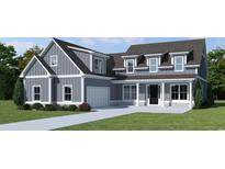 Two-story farmhouse style home with gray siding, white trim, and a large front yard at 364 Ridge Dr., Galivants Ferry, SC 29544