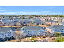 Beautiful condo community with water views, manicured lawns, and attractive multi-story buildings at 3923 Gladiola Ct. # 301, Myrtle Beach, SC 29588