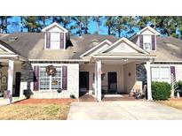 Brick front exterior of charming townhome with welcoming porch at 427 Colonial Trace Dr. # 1 E, Longs, SC 29568