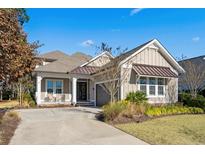Attractive two-story home with a metal roof and landscaped yard at 496 Starlit Way, Myrtle Beach, SC 29579