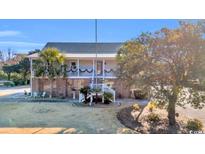 Two-story home with large porch and spacious yard at 5101 Wesley Rd., Murrells Inlet, SC 29576