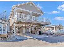Two-story beach house with elevated parking and a spacious deck at 6001-1810 S Kings Hwy., Myrtle Beach, SC 29575