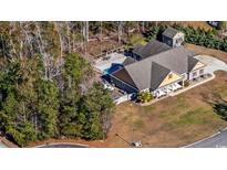 A captivating aerial view showcases the backyard pool, outdoor seating, and lush landscaping at 640 Fox Hollow Rd., Murrells Inlet, SC 29576